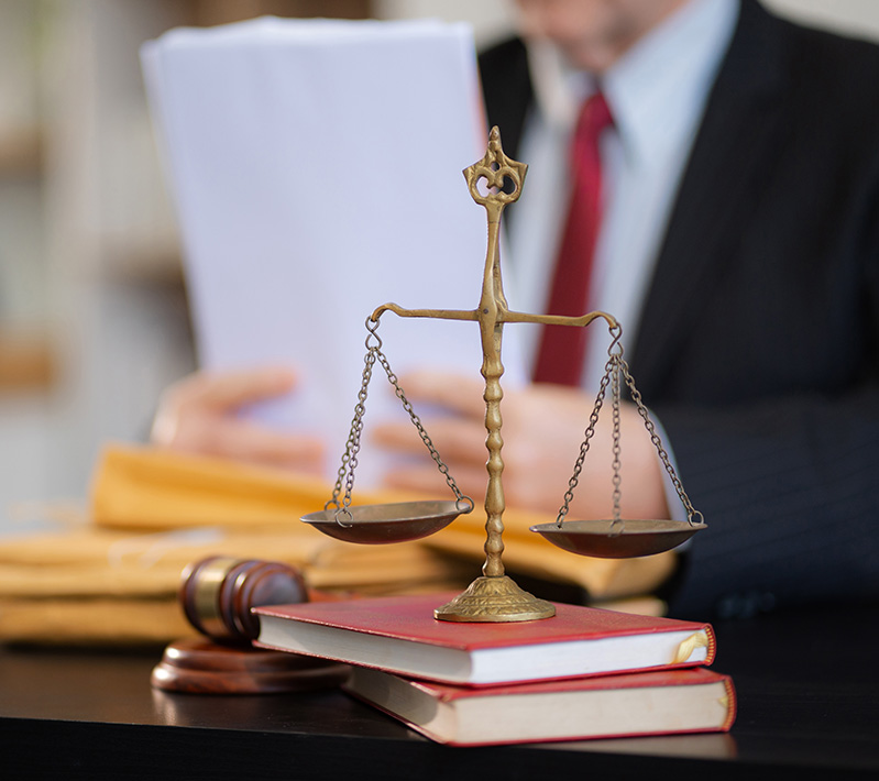 Family law attorney reviewing legal documents with scales of justice