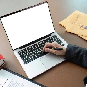 Lawyer working on legal documents with laptop in office setting