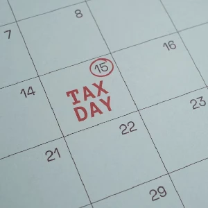 Calendar close-up with "Tax Day" marked in red on the 15th